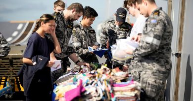 ADF members choose a new Aussie Hero Quilts dhoby bag during HMAS Adelaide's transit to North Queensland. Story by Able Seaman Rikki-Lea Phillips. All photos by Petty Officer Craig Walton.