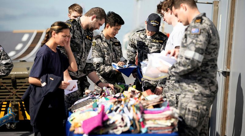 ADF members choose a new Aussie Hero Quilts dhoby bag during HMAS Adelaide's transit to North Queensland. Story by Able Seaman Rikki-Lea Phillips. All photos by Petty Officer Craig Walton.