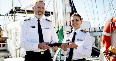 Departing Commanding Officer Sail Training Ship Young Endeavour, Lieutenant Commander Adam Farley, left, hands over the 'Weight' to incoming Commanding Officer Lieutenant Commander Elizabeth Newman. Story by Eliza Jay. Photos by Leading Seaman David Cox.