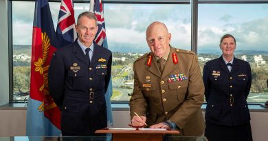 Chief of Joint Capabilities Lieutenant General John Frewen signs the change in command of Space Command document in front of Chief of Air Force Air Marshal Robert Chipman and Commander Defence Space Command Air Vice Marshal Cath Roberts. Story by Peter O'Rourke. Photo by Sergeant Rodney Welch.