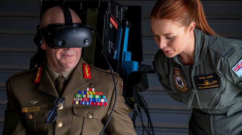 Pilot Officer Georgia Wales leads Head of People Capability, Major General Wade Stothart through the Air Force virtual reality flight simulator during the Defence and Questacon partnership announcement. Story by Corporal Luke Bellman. All photos by Leading Aircraftwoman Annika Smit.