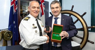 From left, Rear Admiral (retd) Michael Rothwell presents Warrant Officer Matthew Hurley with his Federation Star marking 40 years of service in the Royal Australian Navy during a ceremony at Fleet Headquarters in Sydney. Story by Lieutenant Commander Harley Slatter. Photo by Leading Seaman Matthew Lyall.