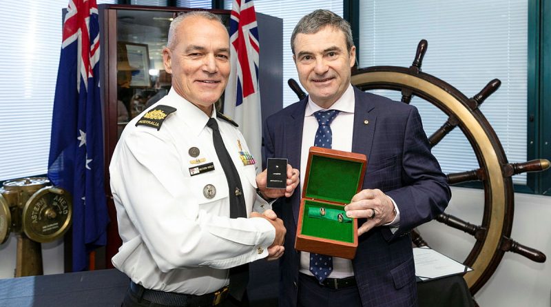 From left, Rear Admiral (retd) Michael Rothwell presents Warrant Officer Matthew Hurley with his Federation Star marking 40 years of service in the Royal Australian Navy during a ceremony at Fleet Headquarters in Sydney. Story by Lieutenant Commander Harley Slatter. Photo by Leading Seaman Matthew Lyall.
