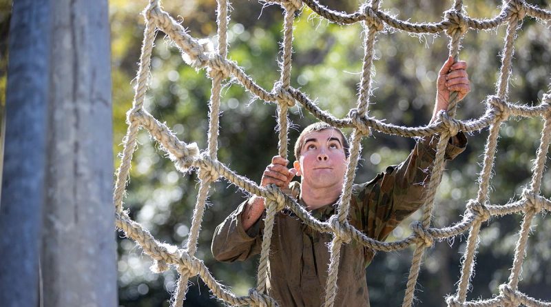 An Australian Army cadet climbs the cargo net during the Chief of Army Cadet Team Challenge 2023 at Kokoda Barracks in Canungra, South Queensland. Story by Stacey Doyle. Photo by Leading Seaman Nadav Harel.