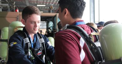 UK Air Cadet Alex Athey helps United States Air Cadet Ishan Swali into his breathing gear at an information session on flight line fire suppression at 23 Squadron during their visit. Story by Flight Lieutenant Julia Ravell.