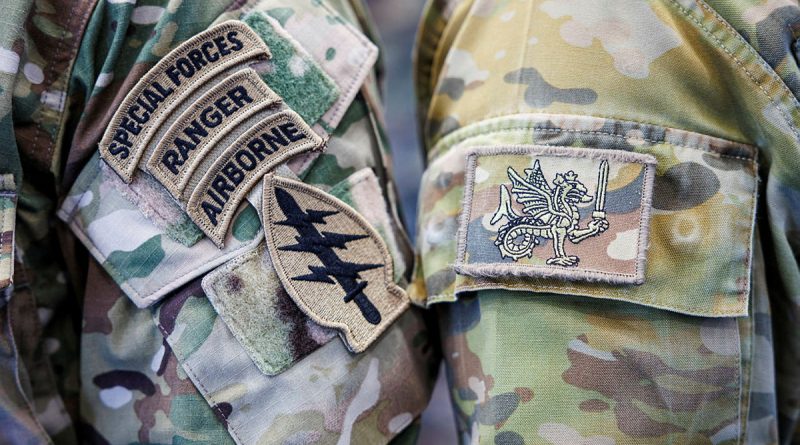 An Australian Army special forces soldier from 2nd Commando Regiment and a United States Army soldier from 1st Special Forces Group (Airborne) prepare for a static-line parachuting training jump side-by-side at RAAF Base Richmond in Sydney. Photos by Corporal Cameron Pegg.