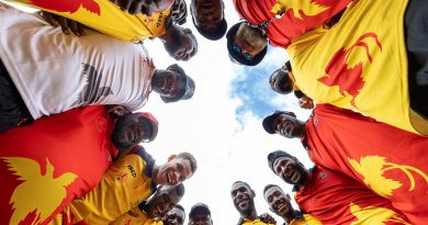Local participants form a huddle during an ADF Sports training program at the Sir John Guise Stadium, Port Moresby, Papua New Guinea. Story by Squadron Leader Amanda Scott. Photo by Leading Seaman Matthew Lyall.