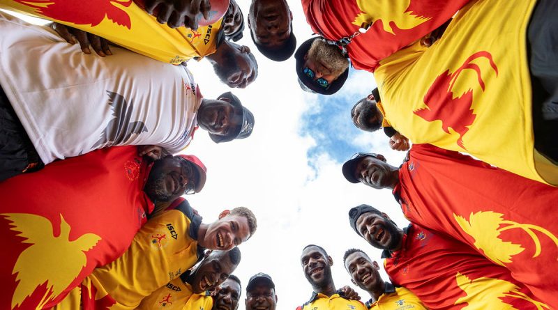 Local participants form a huddle during an ADF Sports training program at the Sir John Guise Stadium, Port Moresby, Papua New Guinea. Story by Squadron Leader Amanda Scott. Photo by Leading Seaman Matthew Lyall.