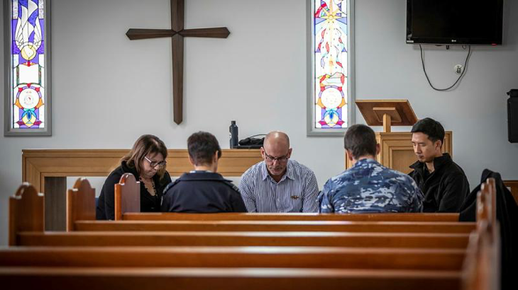 Samuel Hays (centre) leads the National Day of Prayer for Defence at Saint John's protestant chapel at RAAF Base Williamtown. Story and photo by Corporal Melina Young.