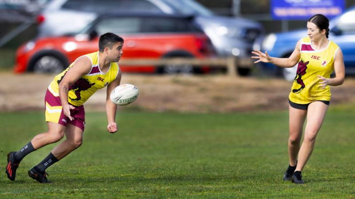 Corporal Jacob Cutmore passes the ball to Captain Charlotte Hargreaves during a game at the 2023 ACT NAIDOC Touch Football carnival on July 15. Story by Private Nicholas Marquis.