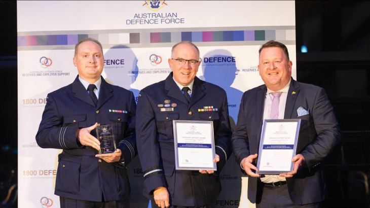 Squadron Leader Nathan Hook, left, with Acting Head Joint Support Services Division Air Commodore Grant Pinder, and civilian employer Peter Nugent from AeroPM. Story by Emily Egan. Photo by Hilary Wardhaugh.