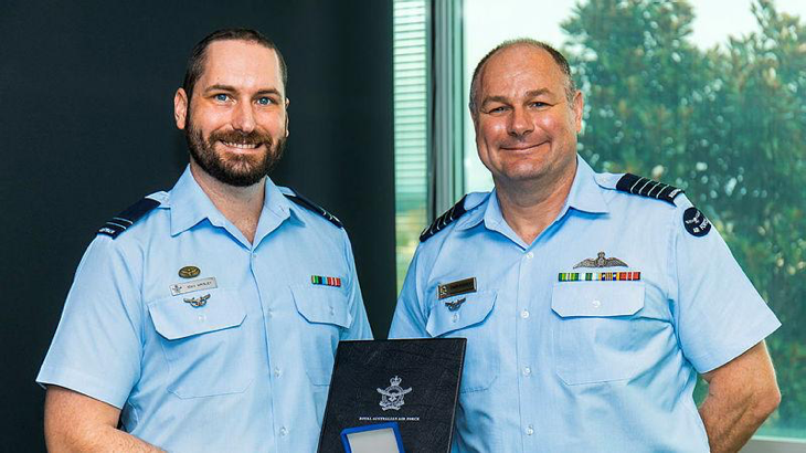 RAAF Flight Lieutenant Sean Wrigley receives a Chief of Air Force Gold Medal Commendation from Director of Aviation Operations Group Captain Chris Pouncey at Fairbairn, ACT. Story by Squadron Leader Barrie Bardoe. Photo by Leading Aircraftman Ryan Howell.
