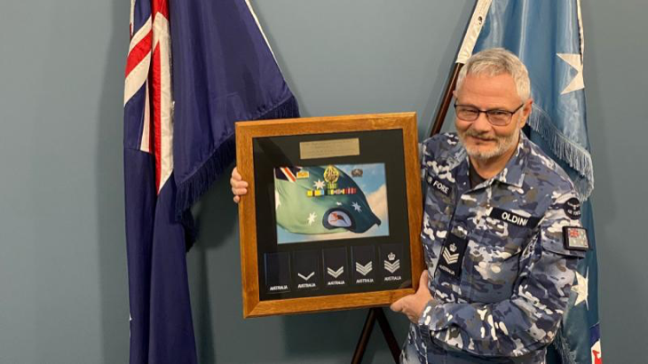 Flight Sergeant Stephen Olding with his presentation gift to mark his retirement from the RAAF. Story by Wing Commander Susan Yates.
