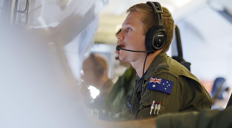 Royal Australian Air Force Flying Officer Harrison Mash coordinates a surveillance and reconnaissance bi-lateral training mission on board a RAAF P-8A Poseidon during a flight in Tamil Nadu, India, at the beginning of Indo-Pacific Endeavour 23. Photo by Corporal Robert Whitmore.