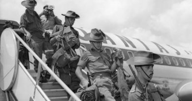 Australian troops disembark a Qantas aircraft to start their tour of duty in Vietnam, at Saigon Airport, April 1966. Photo by WO2 'Billy' Cunneen – AWM CUN/66/0357/VN