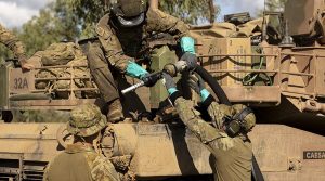 Australian Army soldiers from the 2nd Cavalry Regiment and the 5th Aviation Regiment conduct a refuel on a M1 Abrams tank during Exercise Eagle Walk at Townsville Field Training Area, Queensland. Photo by Lance Corporal Riley Blennerhassett.