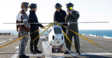 S100 crew from 822X Squadron and Defence Science and Technology Group personnel discuss the S100 bathymetric LiDAR sensor trials on the flight deck of HMAS Adelaide during Exercise Sea Raider. Story by Corporal Luke Bellman. Photo by Able Seaman Rikki-Lea Phillips.