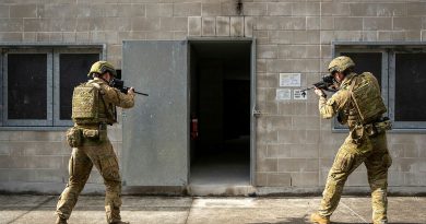 From left, Army soldiers Lance Corporal Timothy Maloney and Private Liam McIvor, from the 9th Battalion, Royal Queensland Regiment, prepare to enter a building during joint training activities at Gallipoli Barracks, Queensland. Story and photo by Private Connor Morrison.