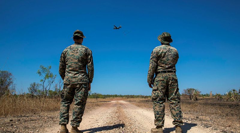 Marine Corps 1st Lieutenant Kevin Arbeznik, left, and Gunnery Sergeant Emmanuel Alvarado observe an airdrop from a RAAF C-27J Spartan at the Mount Bundy Training Area, Northern Territory. Story by Flight Lieutenant Claire Campbell. Photo by Leading Aircraftman Chris Tsakisiris