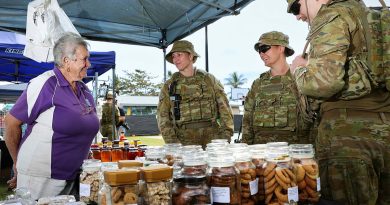 Commander Force Sustainment Group, Colonel Charmaine Benfield, centre, and FSG personnel chat with Mrs Judy Braithwaite at the Ingham, QLD markets during Exercise Talisman Sabre. Story by Lieutenant Geoff Long. Photos by Sergeant David Said.