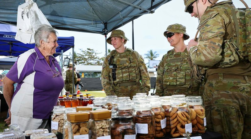 Commander Force Sustainment Group, Colonel Charmaine Benfield, centre, and FSG personnel chat with Mrs Judy Braithwaite at the Ingham, QLD markets during Exercise Talisman Sabre. Story by Lieutenant Geoff Long. Photos by Sergeant David Said.