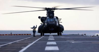 A Royal Australian Navy aviation support sailor marshals a United States Army MH-47G Chinook after it landed on HMAS Adelaide during Exercise Balance Action. Story by Captain Sarah Kelly. Photo by Able Seaman Rikki-Lea Phillips.