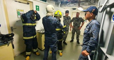 NUSHIP Arafura Petty Officer Darren Young, left, and Chief Petty Officer Matthew Hitchcock, observe Royal Brunei Navy sailors during a fire-fighting exercise aboard KDB Darulehsan off the coast of Brunei. Photo by Rhody Gleeson.