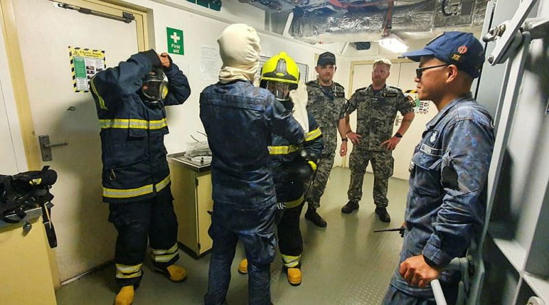 NUSHIP Arafura Petty Officer Darren Young, left, and Chief Petty Officer Matthew Hitchcock, observe Royal Brunei Navy sailors during a fire-fighting exercise aboard KDB Darulehsan off the coast of Brunei. Photo by Rhody Gleeson.