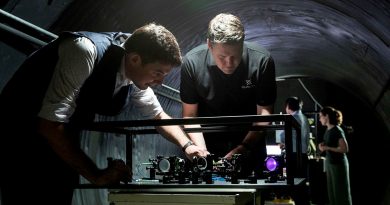Defence Science and Technology Group scientist Dr Ben Sparkes, left, works with Australian-built quantum clocks at the University of Adelaide.
