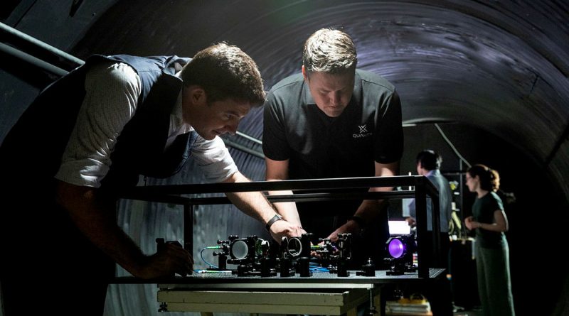 Defence Science and Technology Group scientist Dr Ben Sparkes, left, works with Australian-built quantum clocks at the University of Adelaide.