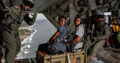 RAAF loadmasters Flight Sergeant Andrew Coates (left) and Sergeant Daniel Saunders, along with local news reporters, enjoys the views of the Port Vila coastline from the ramp of the C-27J Spartan aircraft during a maritime surveillance flight out of Port Vila, Vanuatu. Story buy Lieutenant Nic Hawkins. Photos by Sergeant David Cotton.