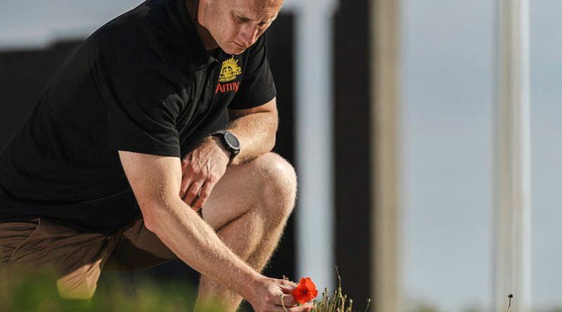 Jonathan Church Good Soldiering Award ambassador Corporal Justin Wells picks a poppy beside the Le Hamel Australian Corps Memorial, France. Story and photos by Corporal Jacob Joseph.