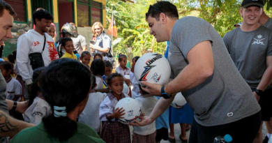 An Australian Army Football Northern Territory team member gives a soccer ball to a child from the Santa Teresinha school in Liquiçá, Timor-Leste, during Indo-Pacific Endeavour 2023. Story by Flight Lieutenant Claire Burnet. Photos by Leading Aircraftman Samuel Miller.