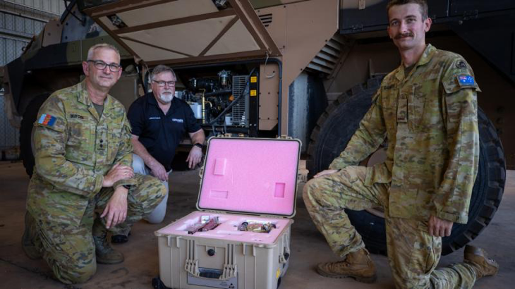 Project Manager for Land 2072 Phase 2B, from left, Lieutenant Colonel Matthew Kitchin, project lead Mr Dafydd Gwynn-Jones and Signaller Harry Saunders, stand in front of the new 'Protected Mobility Headquarters on the Move' Bushmaster variant at the 1st Combat Signals Regiment in Darwin, NT. Story by Captain Annie Richardson.