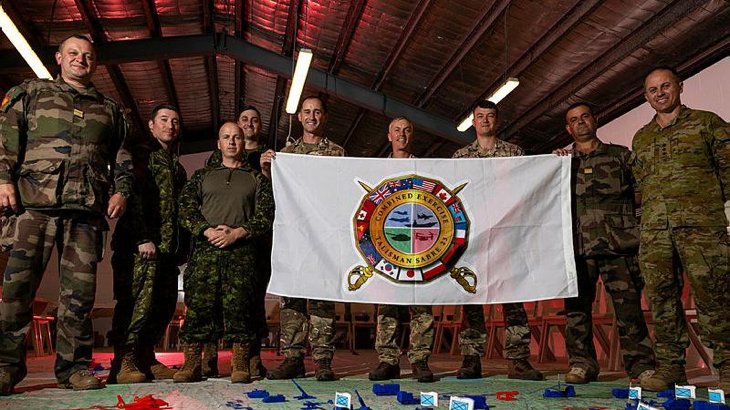 International participants of Exercise Talisman Sabre, representing the Combat Training Centres of France, Canada and the UK, with Colonel Ben McLennan (ADF), far right. Story by V. Photo by Corporal Julia Whitwell.
