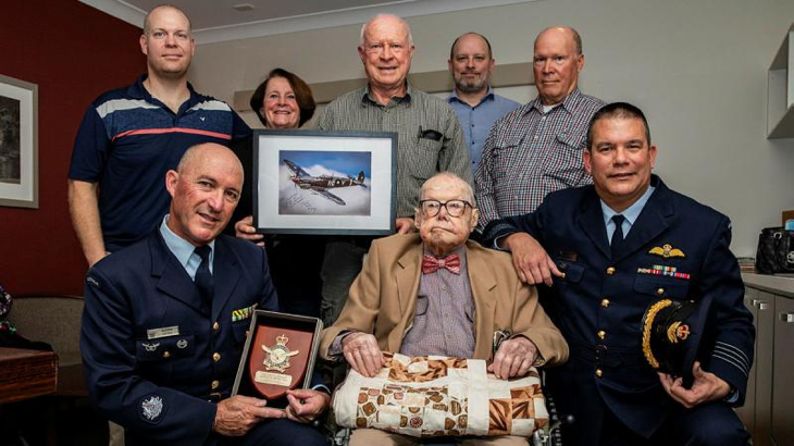 Senior ADF Officer RAAF Base Amberley, Group Captain Dennis Tan (right), and Warrant Officer Glenn Lyons (left) with Air Force veteran John Shoesmith and his family to celebrate his 100th birthday. Story by Flight Lieutenant Rob Hodgson. Photo by Leading Aircraftwoman Taylor Anderson.