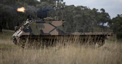 An Australian Army M113AS4 armoured logistics vehicle, fitted with optionally crewed combat vehicle technology and a remote weapon station, fires from a support-by-fire position during a human-machine team exercise. Story and photo by Sergeant Matthew Bickerton.