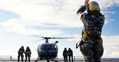 Leading Seaman Kendall Warner marshals an Indian Navy Chetak helicopter on board HMAS Choules during Exercise Malabar 2023, NSW. Story by Sub-Lieutenant Tahlia Merigan. Photo by Leading Seaman David Cox.