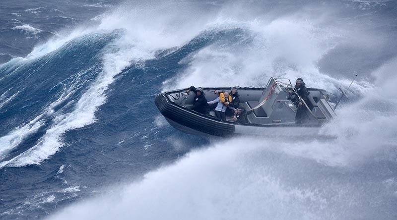 The RHIB crew from HMNZS Te Mana, with the saved yachtsman, battling big seas off Great Barrier Island during Cyclone Gabrielle. NZDF image supplied.