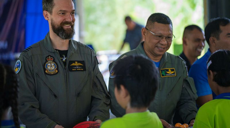RAAF Wing Commander Sean Hamilton and Royal Thai Air Force Group Captain Sithipol Pomtri pass gifts to students during Exercise Thai Boomerang. Story by Flight Lieutenant Rob Hodgson. Photos by Leading Aircraftman Ryan Howell.