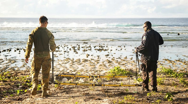 Australian Army explosive ordnance disposal technician Corporal Joel Macmillan, left, and Royal Solomon Islands Police Force Constable Armstrong Ragoso survey the coastline using metal detection equipment during Operation Render Safe, Nauru. Story by Captain Karam Louli. Photos by Corporal Sam Price.