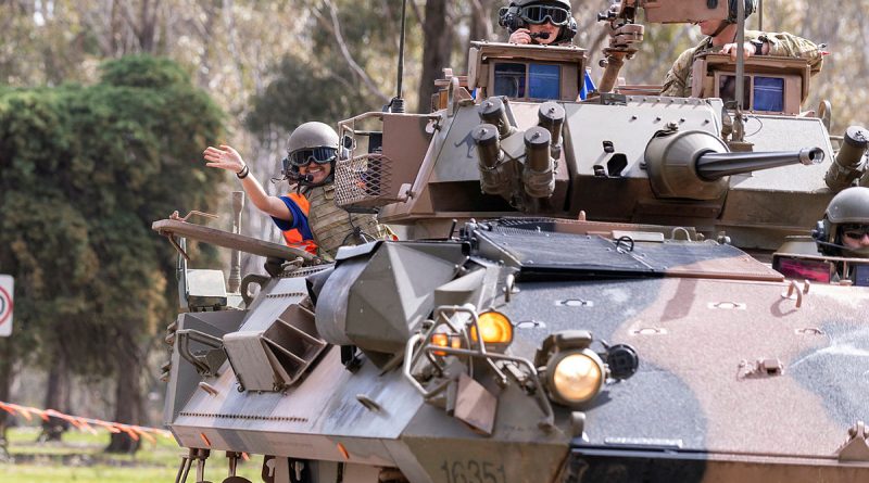 Defence Work Experience Program participants Alexandra Ibrahim and Angella Dcunha, of Saint Monica, get ready to go for a ride in an Australian light armoured vehicle during an open day for school students at Puckapunyal. Story by Captain Carlie Gibson. Photos by Corporal Michael Currie.
