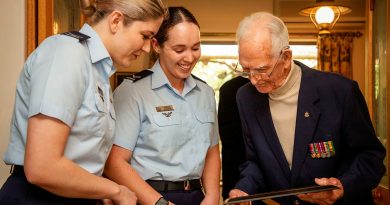 Leading Aircraftwomen Erica Moy and Tahlia Kitchin, from 83 Squadron, and Lyall Ellers reflect on his Air Force service during his 100th birthday celebrations held at his home in Seacliff, Adelaide, SA. Photos by Sergeant Nicci Freeman.