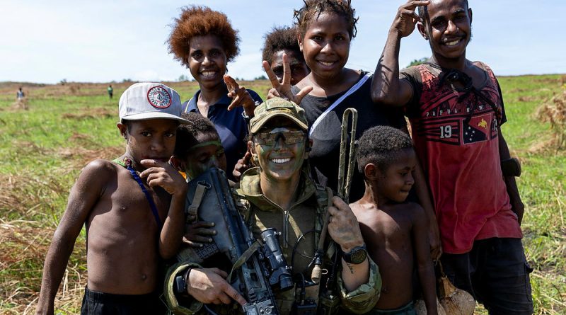 Australian Army officer Lieutenant Samantha May, of the 3rd Battalion, the Royal Australian Regiment, with local children in Papua New Guinea. Story by Captain Diana Jennings. Photos by Leading Aircraftwoman Emma Schwenke.
