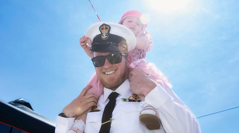 Petty Officer Roland Brew with his daughter at the Members and Family Day in HMAS Watson, Sydney. Story by Sub-Lieutenant James Murphy. Photos by Sittichai Sakonpoonpol.