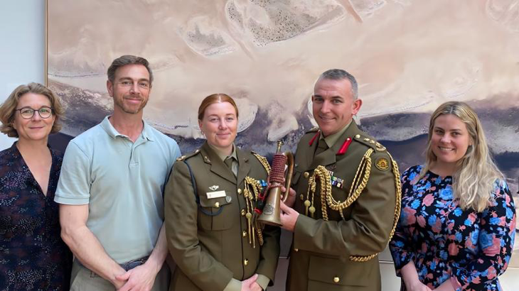 (L-R) Katia Hoffmann, Luke Giacomin, Australian Army officers Major Jess Ward, Colonel Paul Graham and Sharna Roberts with a fake vintage Western Australian University Regiment bugle. Story by Sergeant Matthew Bickerton.
