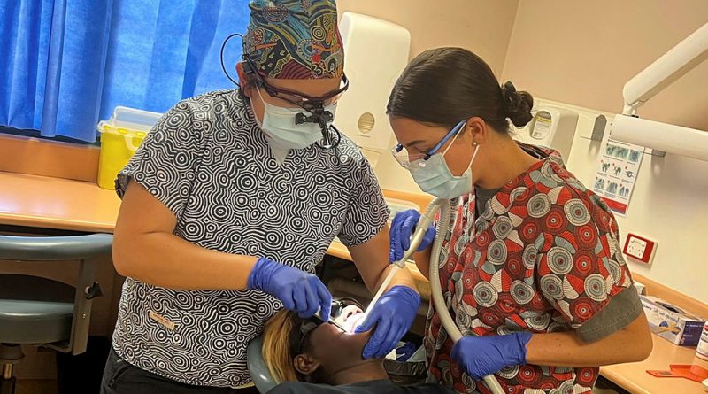 Dental officer Flight Lieutenant Alexis Dieu, left, and dental assistant Leading Aircraftwoman Ocean Mitchell, both from 2 Expeditionary Health Squadron, treat a patient at Wadeye, NT, during a remote NT Health dental visit. Story by Flight Lieutenant Claire Campbell. Photo by Flight Lieutenant Yuen Dieu.