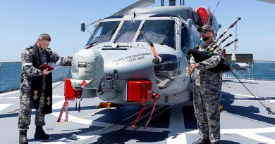 Royal Australian Navy Chaplain Bradley Galvin, left, and Commanding Officer HMAS Toowoomba Commander Darin MacDonald during a blessing ceremony for the embarked MH-60R helicopter Valkyrie. Story and photos by Leading Seaman Ernesto Sanchez.