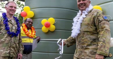 Lieutenant Colonel Glenn Mackenzie (right), Commanding Officer of Operation Lilia, cuts the ribbon on water tanks delivered through an ADF-led community infrastructure project at a handover event in the Gilbert Camp community. Story by Sergeant Felicity Richardson and Major Simon Hampson. Photo by Warrant Offer Class 1 Bruce McLean.