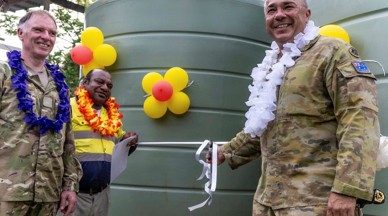 Lieutenant Colonel Glenn Mackenzie (right), Commanding Officer of Operation Lilia, cuts the ribbon on water tanks delivered through an ADF-led community infrastructure project at a handover event in the Gilbert Camp community. Story by Sergeant Felicity Richardson and Major Simon Hampson. Photo by Warrant Offer Class 1 Bruce McLean.